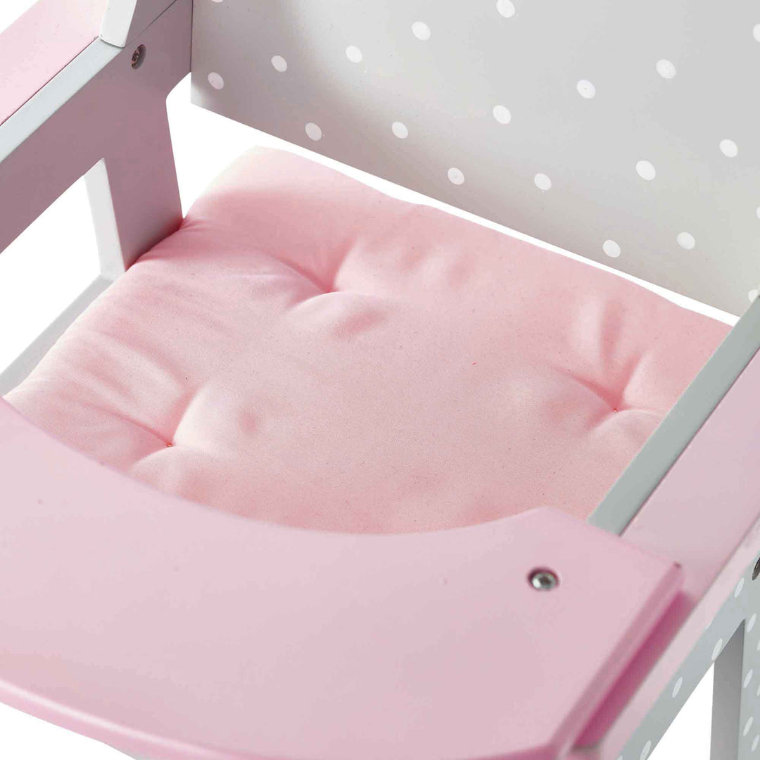 A close-up of the pink cushion of the pink and grey with white polka dots baby doll high chair.