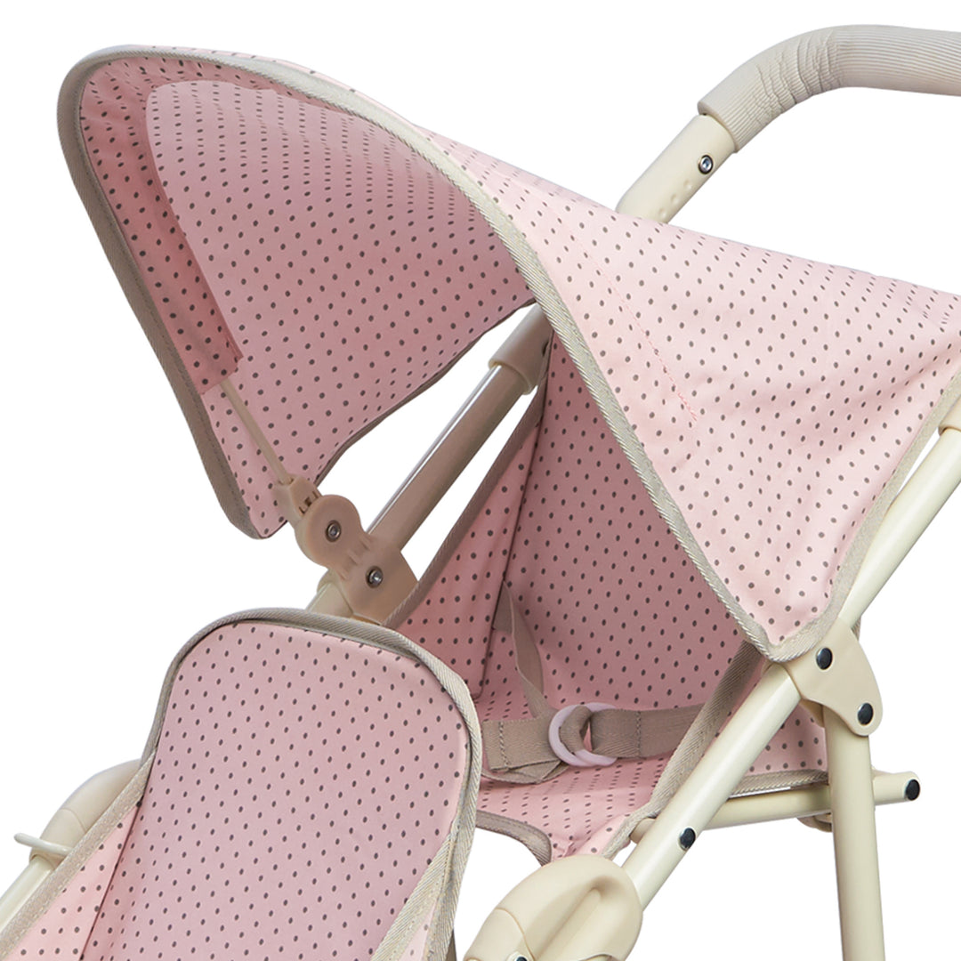 Close-up of the retractable canopy and the back seat of the baby doll tandem jogging stroller, pink with gray polka dots.