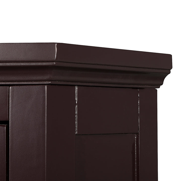 Close-up of the crown molding on the top of the Dark Brown Glancy Corner Floor Cabinet with a louvered door and a chrome knob