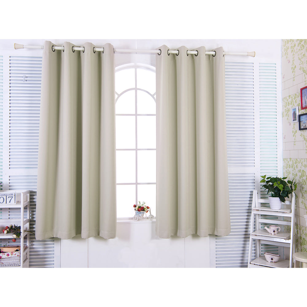 Teamson Home 84" Tripoli Premium Solid Insulated Thermal Blackout Window Curtain Panels with Grommets, Oyster hung on a metal rod in a bright room with a white-framed window.