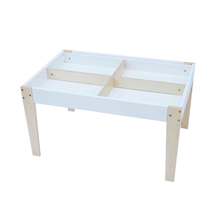 The interior of a child-sized white table divided into four section.