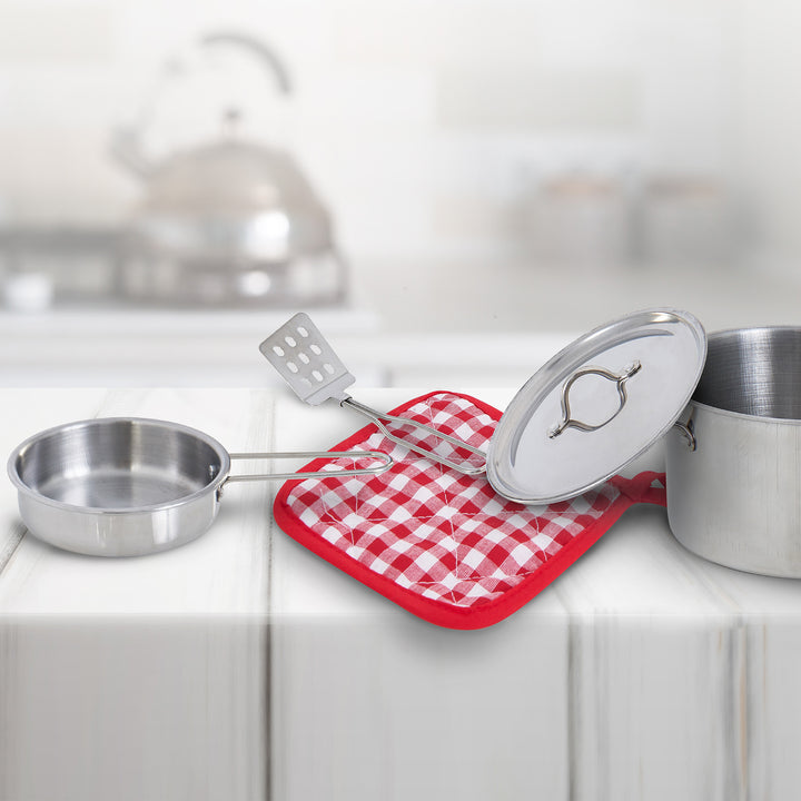 Teamson Kids 11 Piece Little Chef Frankfurt Stainless Steel Cooking Accessory Set with stainless steel finishes and a spatula positioned on a red and white checkered potholder in a bright kitchen setting.