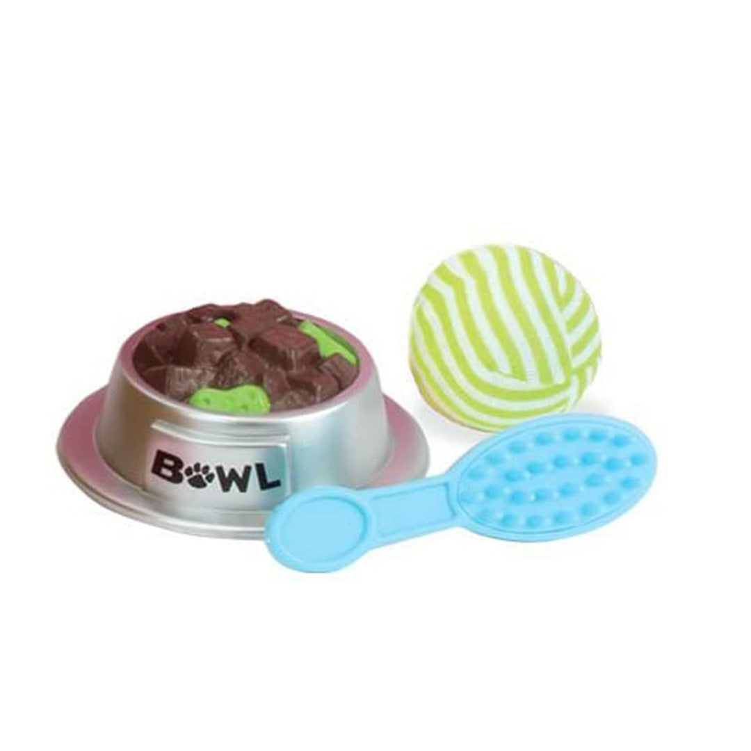 A bowl of pretend play food and a brush next to it for Sophia’s Plush Puppy and Accessories Set for 18" Dolls.
