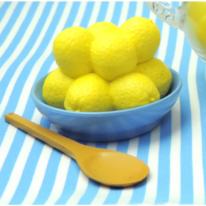 A bowl of lemons and a spoon, part of Sophia’s Fresh Lemonade Drink Set with Pitcher for 18" Dolls.