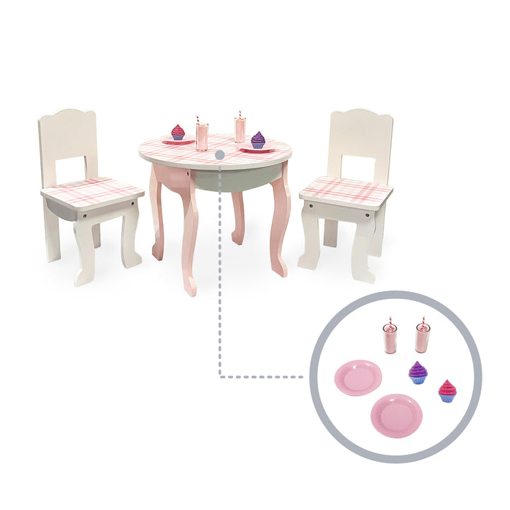 Callout of the 6-piece dessert accessory set (2 pink plates, 2 cupcakes, 2 pink milkshakes) on the table in white with a pink plaid print.