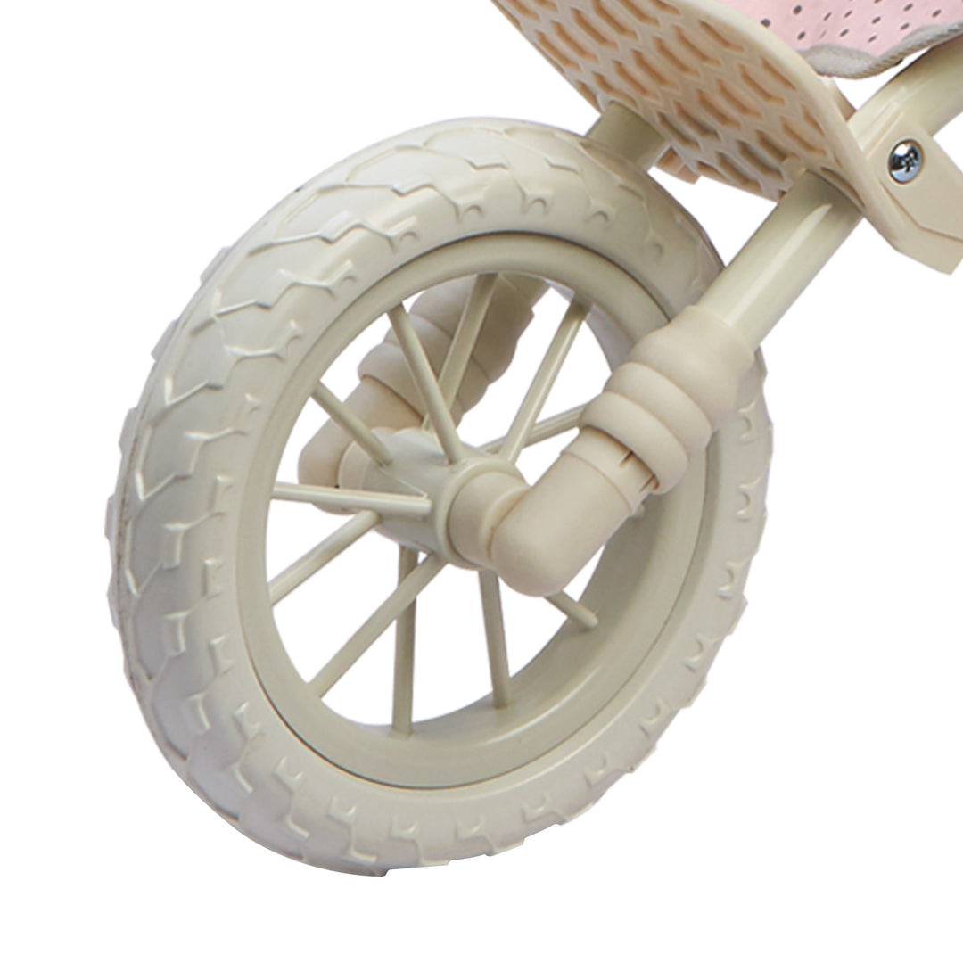 Close-up of the all-terrain front white wheel of the baby doll tandem jogging stroller.