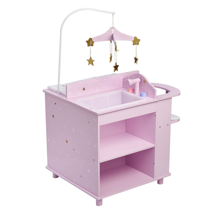 A baby doll changing station in purple with white and gold stars with a focus on the sink bathtub and shelving.