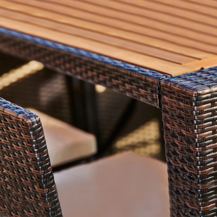 Close-up of a Teamson Home 5 Pc Outdoor Wicker Dining Set with Acacia Tabletop and Cushions, Brown.