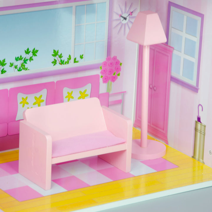 A pink sofa and floor lamp in a living room in a doll house.