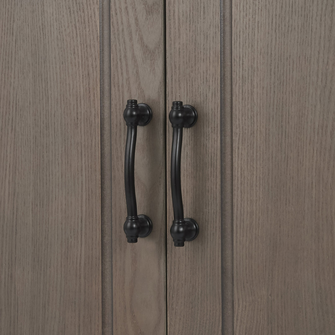 Close-up of the black metal pull handles on the Russell Floor Cabinet in Salt Oak