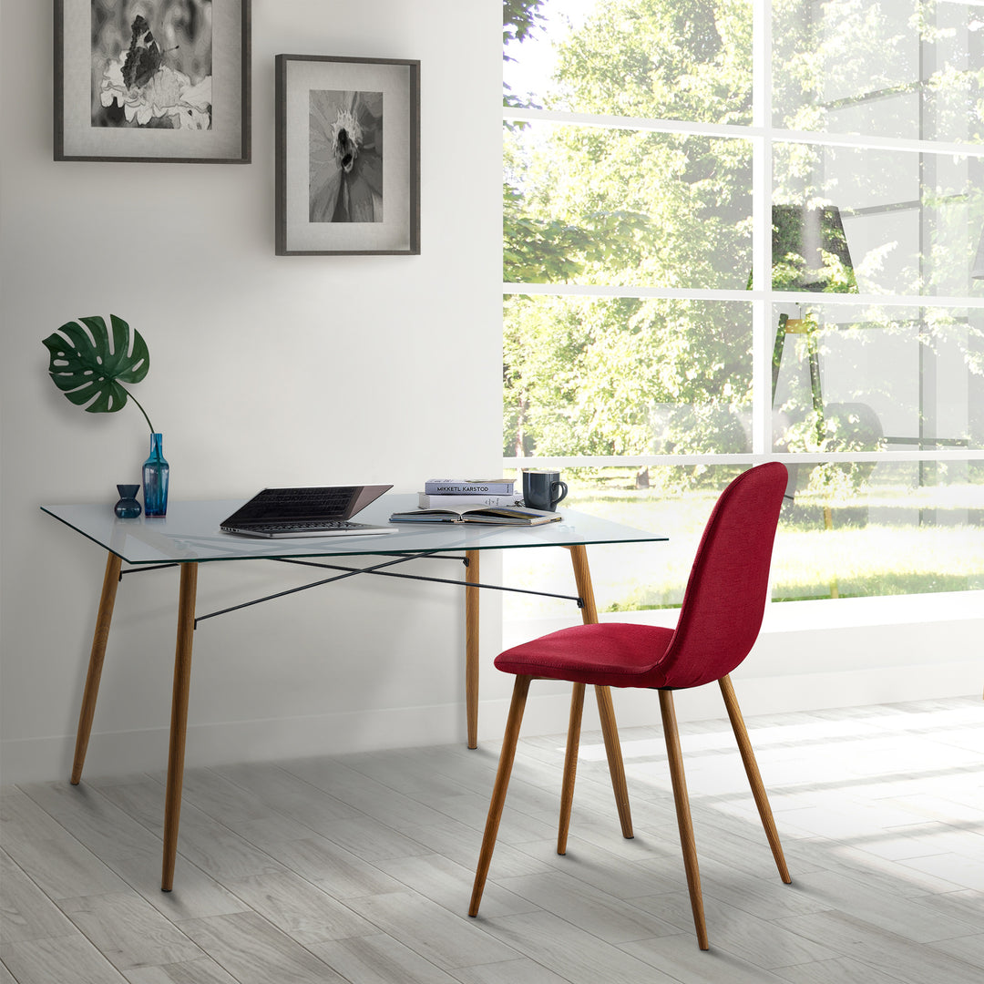 Teamson Home's Minimalist Glass Top Dining Table with a laptop and a red chair next to a big window