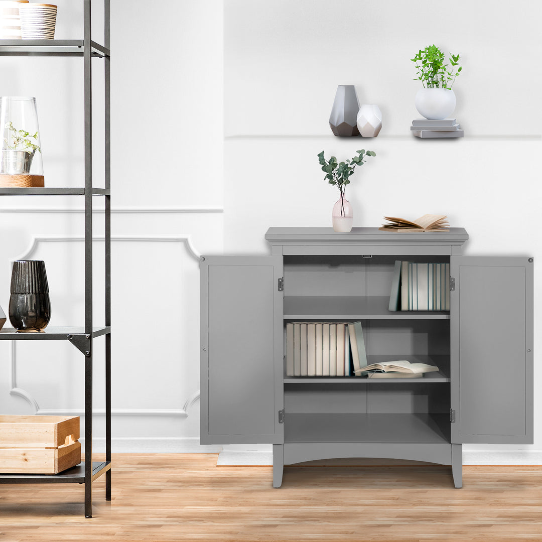 Teamson Home Gray Glancy Floor Cabinet with two louvered doors with the cabinet open and books on the shelves