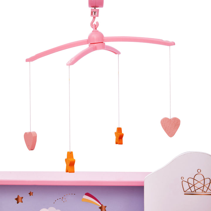 A close-up of a pink mobile that hangs over the crib portion of the baby doll changing station with hearts and stars.