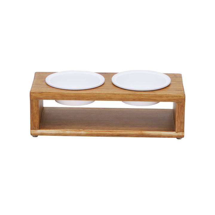 A view of a elevated pet feeder with two white ceramic bowls.
