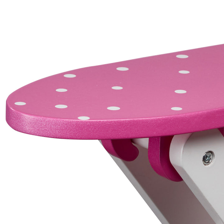 Close-up of ironing board with a pink with white polka dots.