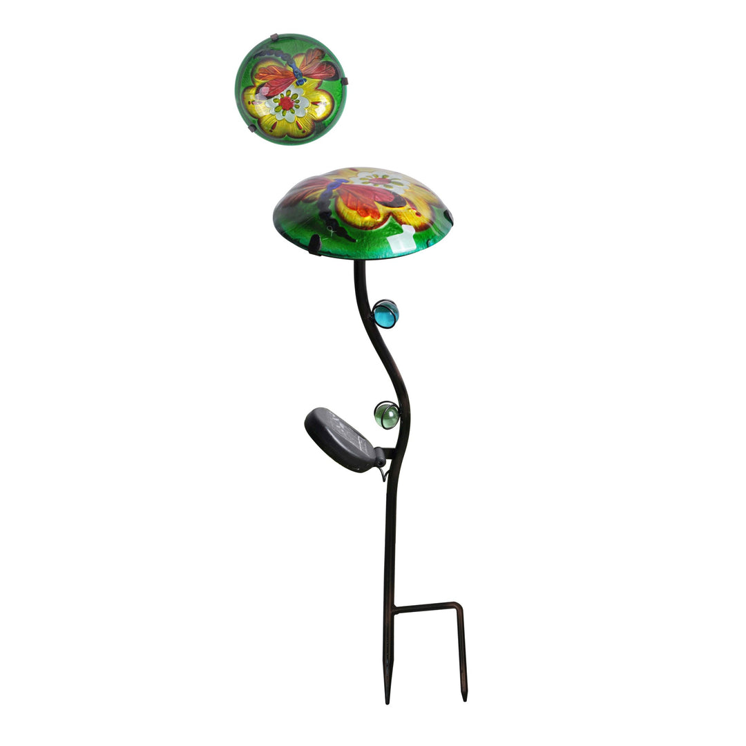 A fusion glass solar-powered garden stake, green with a yellow flower and a red and blue dragonfly