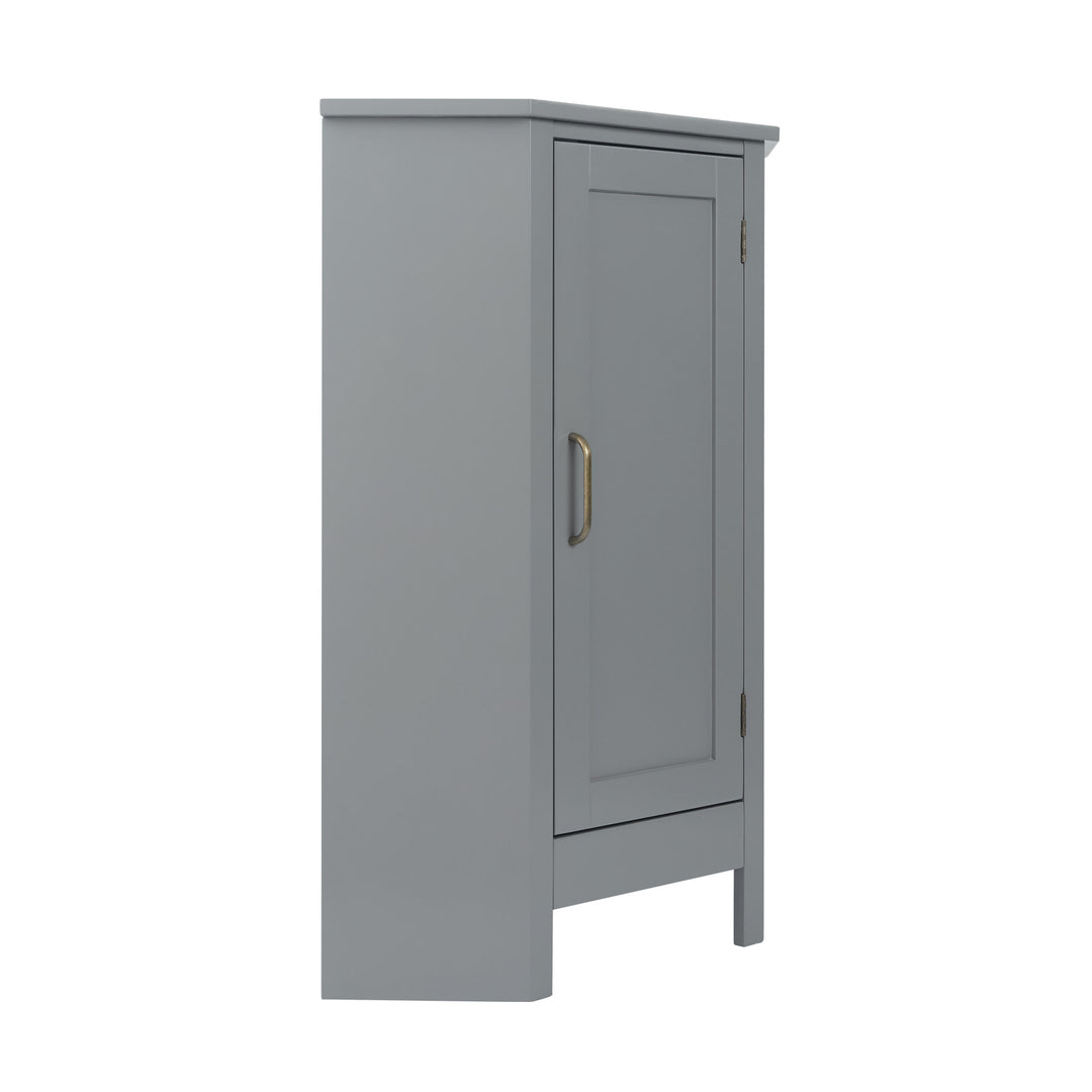 The side view of a Teamson Home Mercer Mid Century Modern Gray Corner Floor Storage Cabinet with a brass pull handle