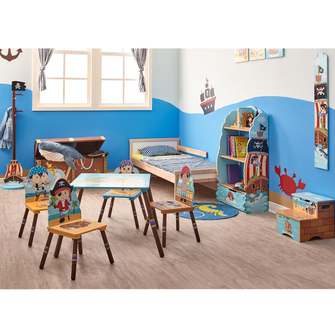 A child's bedroom with a pirate theme with a table and four chairs, a bookshelf, stepstool, storage chest, wall  hangings and a coat tree. Ilustrated with ships, pirates, jolly roger flags, crabs and green parrots.