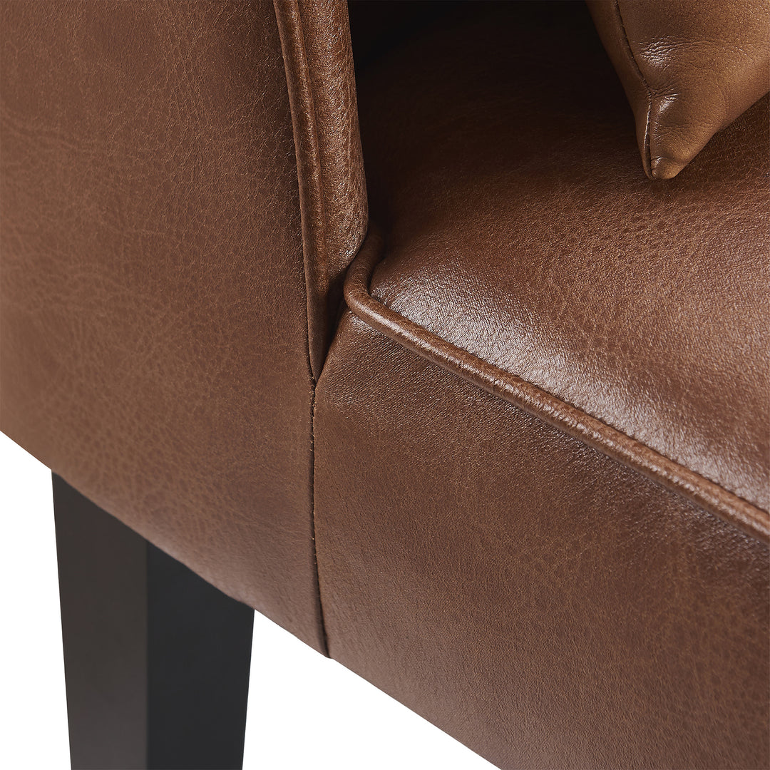 A close up of a comfortable brown Teamson Home Marc Faux Leather Lounge Chair with Pillow and Solid Wood Legs.