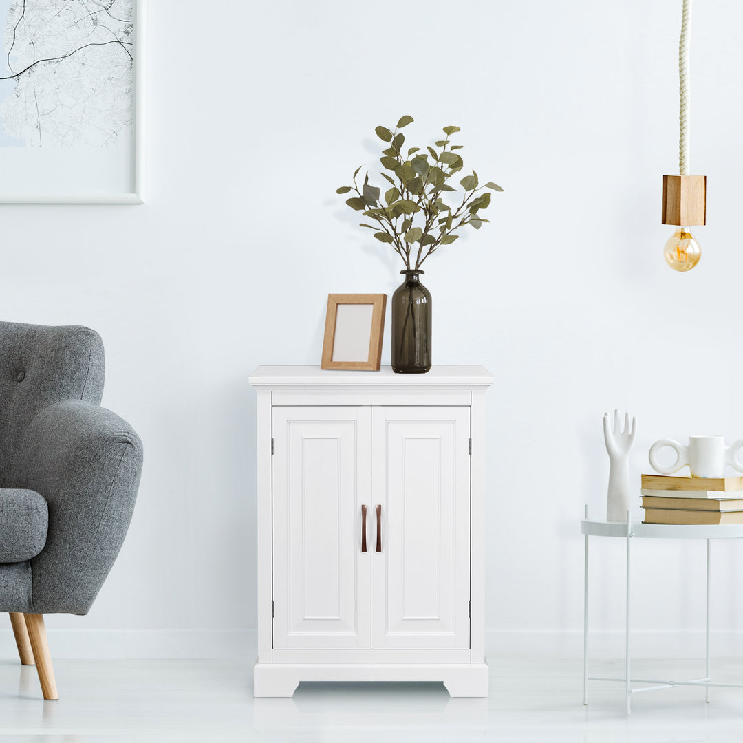 Modern minimalist living room with a White Teamson Home St. James Two-Door Floor Cabinet with raised door panels,  with a decorative plant, hanging pendant light, and gray armchair.