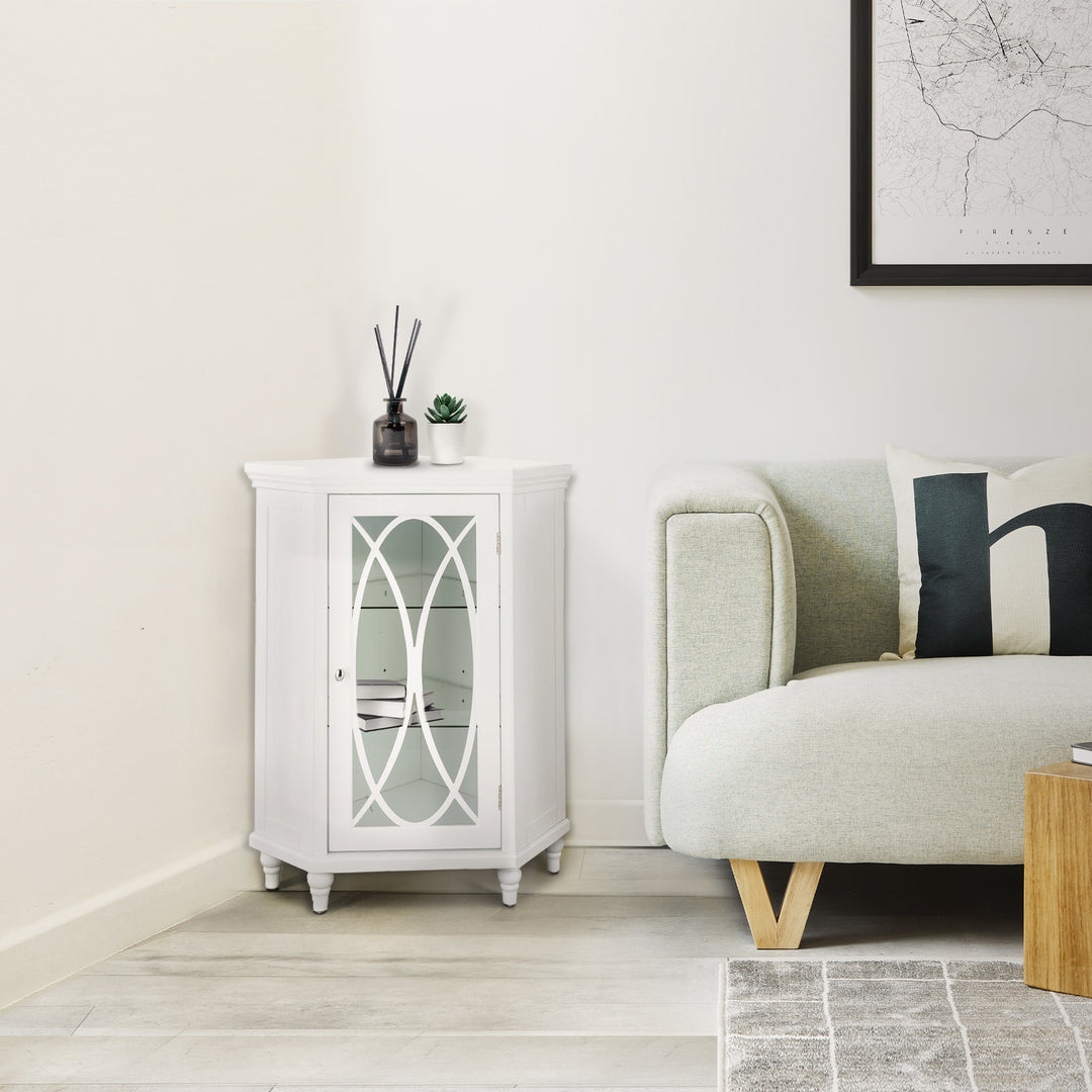 White Teamson Home Florence Corner Floor Cabinet with lattice-designed glass panel door next to a white sofa 