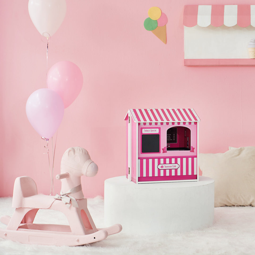 A pink room with a rocking horse with a rounded platform and the doll cafe playset on top.