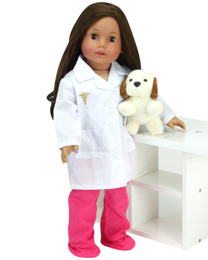 A doll dressed in pink surgical scrubs and shoe covers and a white lab coat stands next to a toy white and brown beagle.
