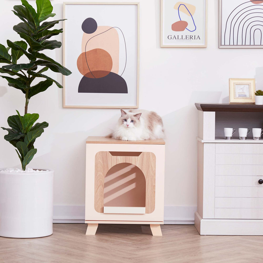 Teamson Pets Elyse Elevated Vented Wooden Cat Litter Box Enclosure Side Table, Tan and White, with a cat laying on the top.