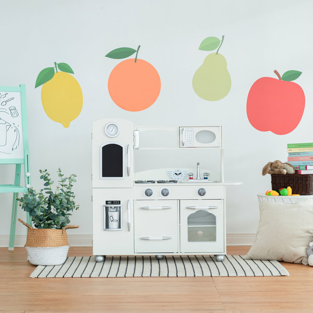 Children's Teamson Kids Little Chef Westchester Retro Kids Kitchen Playset, Ivory with interactive features in a room decorated with colorful fruit stickers on the wall.