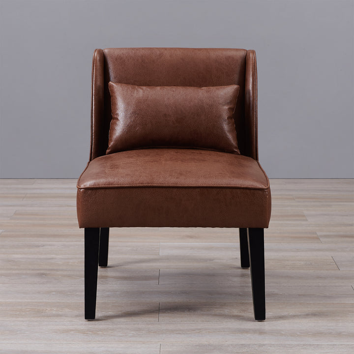 A comfortable brown Teamson Home Marc Faux Leather Lounge Chair with Pillow and Solid Wood Legs on a wooden floor.