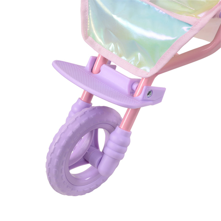 A close-up of a purple all-terrain wheel on an iridescent baby doll jogging stroller.