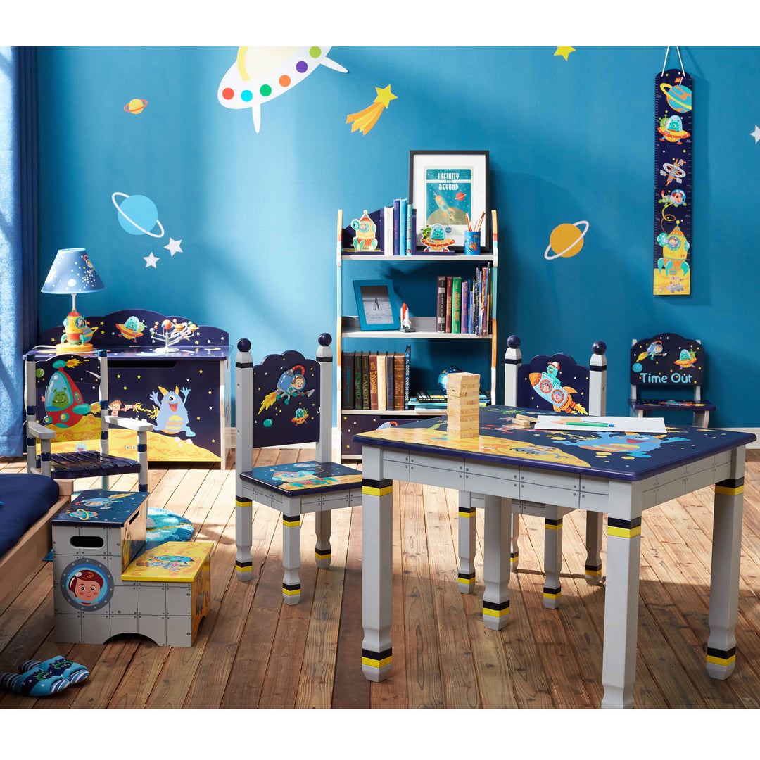 A children's room with a space theme featuring a Fantasy Fields Kids Wooden Outer Space collection - height chart, book shelf, toy box, three chairs, step stool and table.