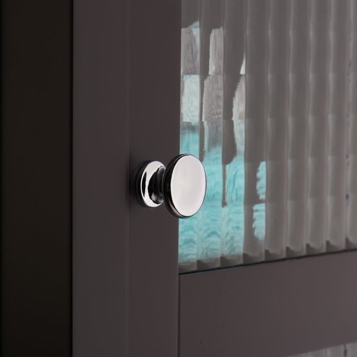A close up of a a chrome knob on the Teamson Home Chesterfield Wooden Floor Cabinet with Waffle Glass Door, Espresso