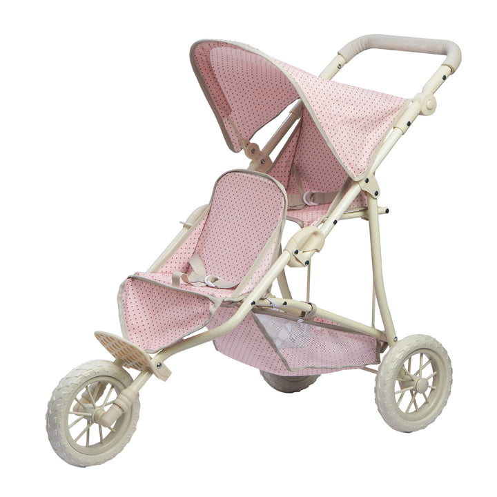 A side view of the pink with gray polka dots and white frame and wheels baby doll tandem jogging stroller.