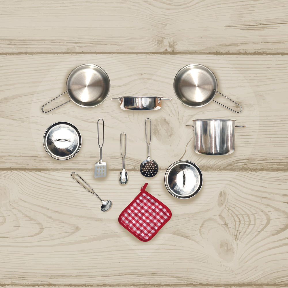 Various cooking utensils from the Teamson Kids 11 Piece Little Chef Frankfurt Stainless Steel Cooking Accessory Set arranged in a heart-like pattern on a wooden surface.