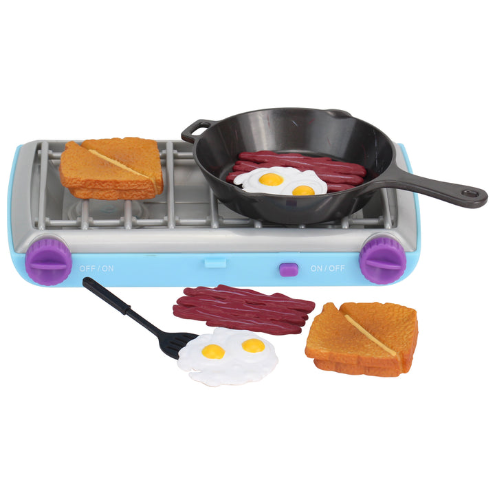 A camp stove and food set for 18" dolls, including a 2 sandwiches, bacon and eggs, a faux cast iron pan, a spatula, and a blue camp stove with purple dials.