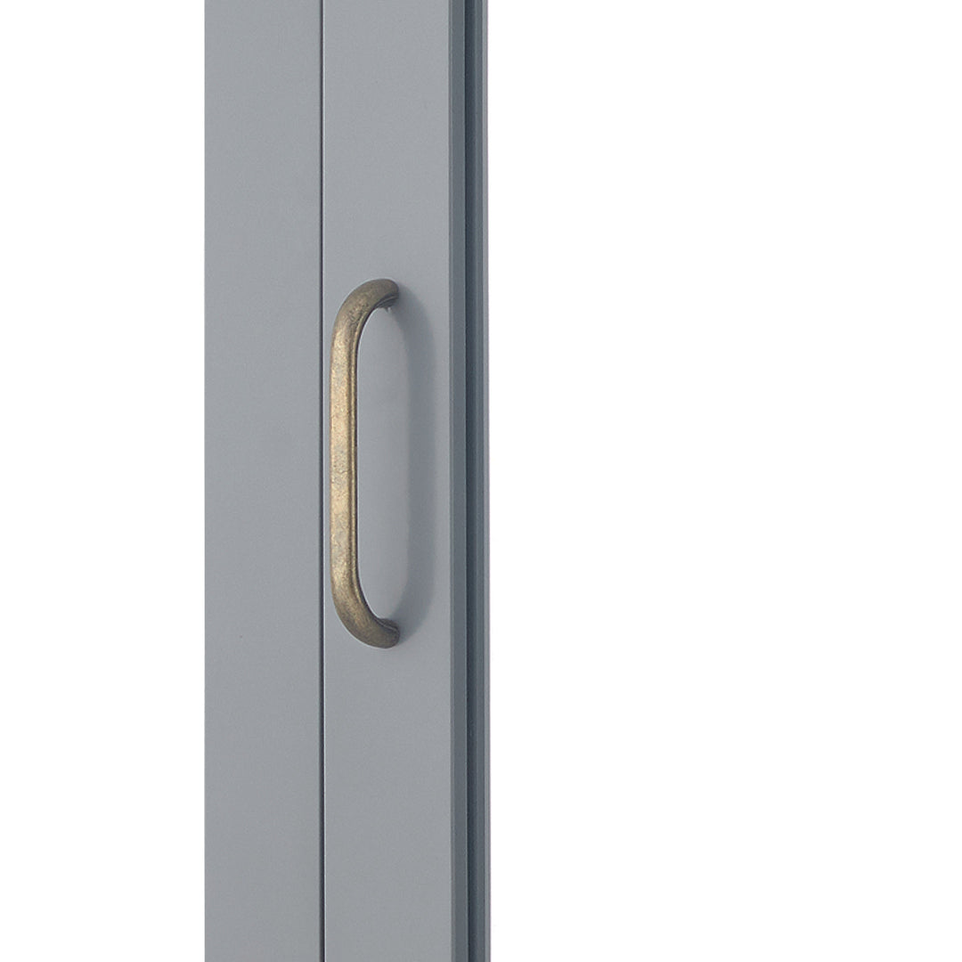 Close-up of brass pull handle of a Gray Mercer Removable Mirrored Medicine Cabinet