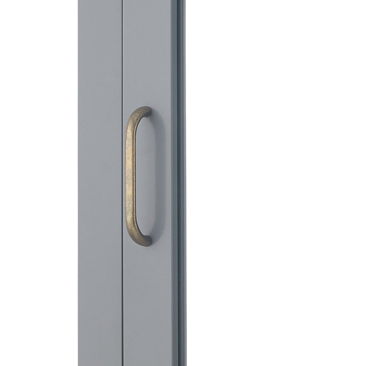 Close-up of brass pull handle of a Gray Mercer Removable Mirrored Medicine Cabinet