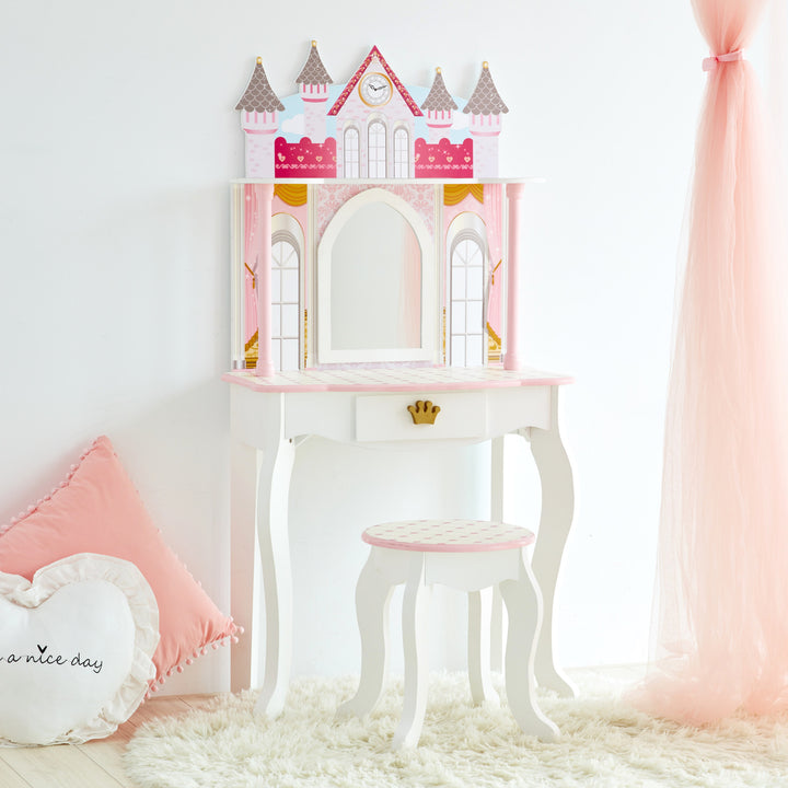 A pink and white Fantasy Fields Kids Dreamland Castle vanity set with a stool.