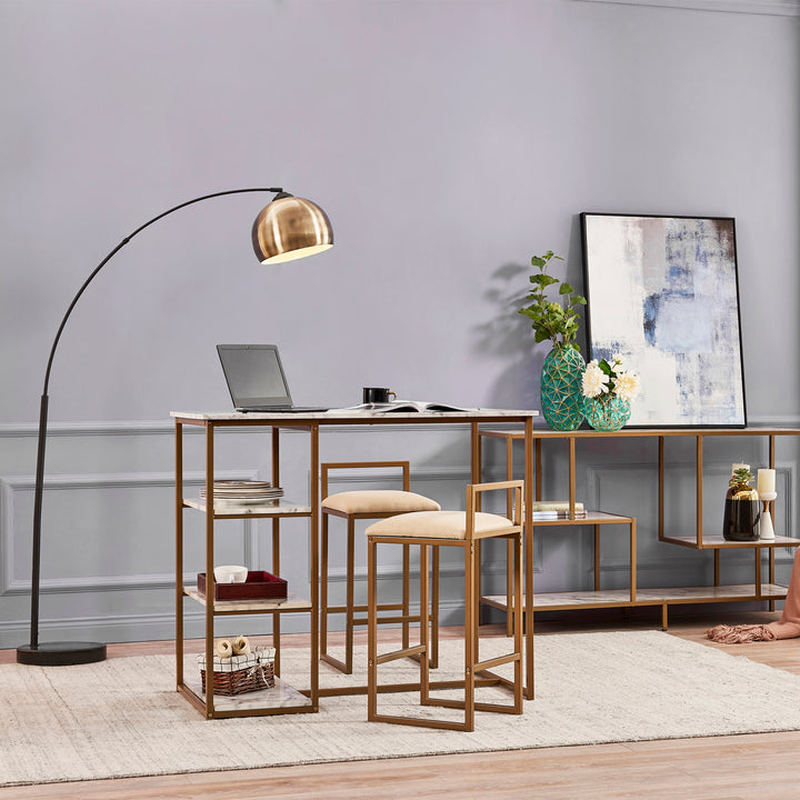 A Teamson Home Marmo Modern Breakfast Table Set in Faux Marble/Brass sat next to an arc lamp and side table