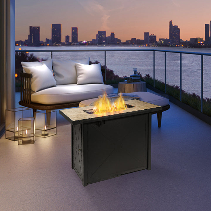 Teamson Home 42" Outdoor Rectangular Propane Gas Fire Pit with Steel Base, Black and seating overlooking a city skyline at dusk.