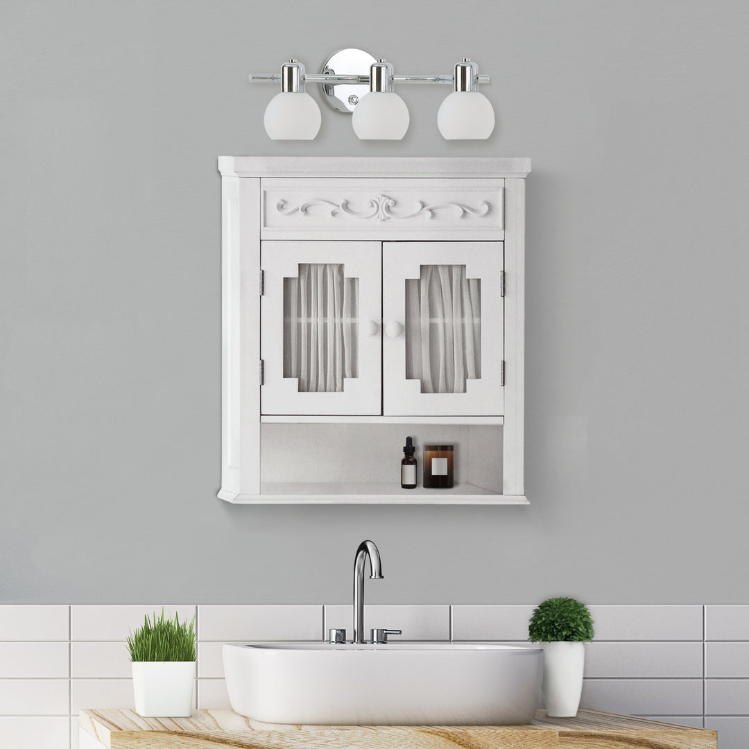 Teamson Home White Lisbon Removable Wall Cabinet mounted over a sink and underneath a 3-light vanity fixture in a gray bathroom