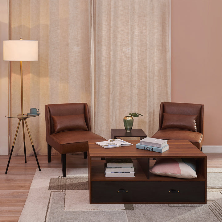 A living room with a comfortable Teamson Home Marc Faux Leather Lounge Chair with Pillow and Solid Wood Legs, Brown, a coffee table, and chairs.
