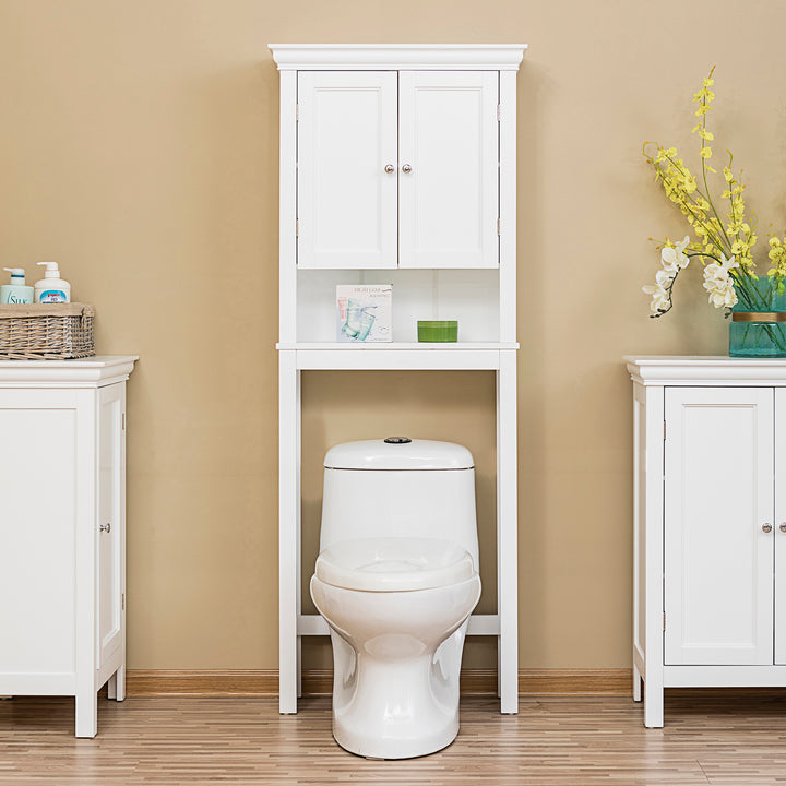 A White Teamson Home Stratford Over-the-Toilet Cabinet with an Open Shelf sat between two floor cabinets in a tan bathroom