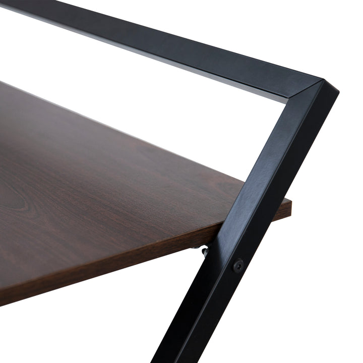 A close up of the desktop and frame where the desk folds