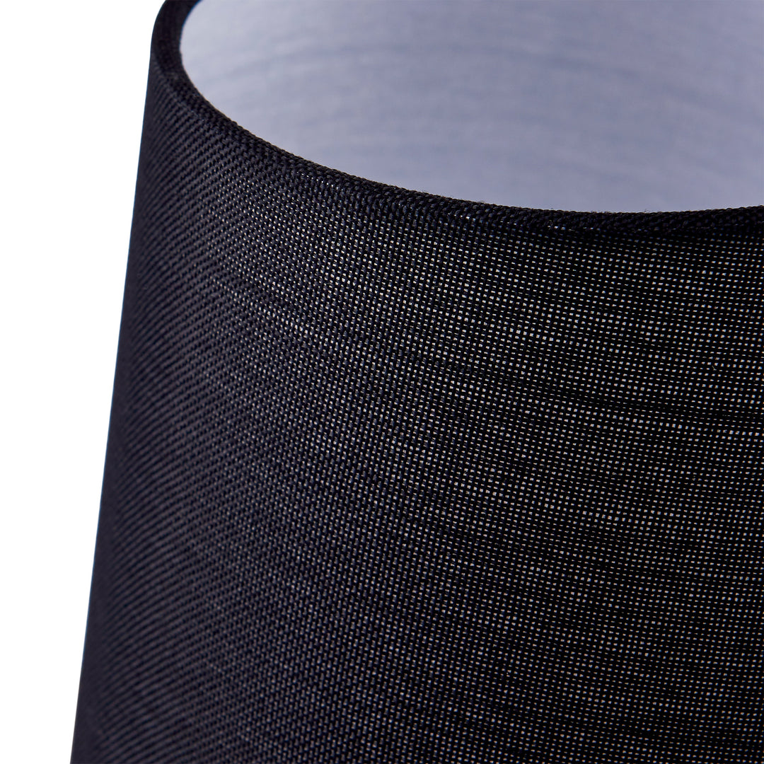 A close up of a black lamp shade on a Teamson Home Aria 15" Modern Table Lamp with Round Shade.