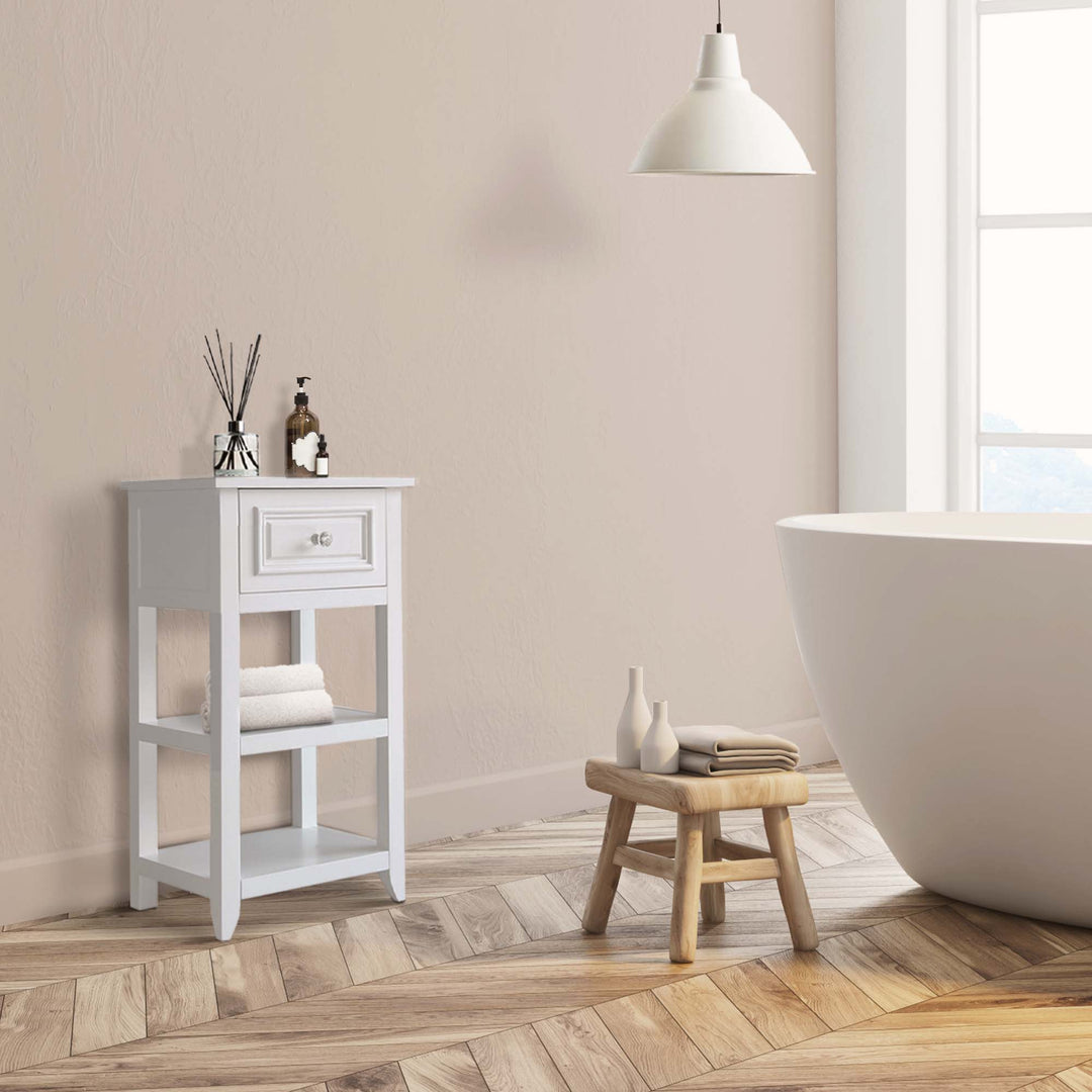 A white bathroom with a durable bathtub, a stool and the Teamson Home Dawson Accent Table with storage drawer and shelves, White