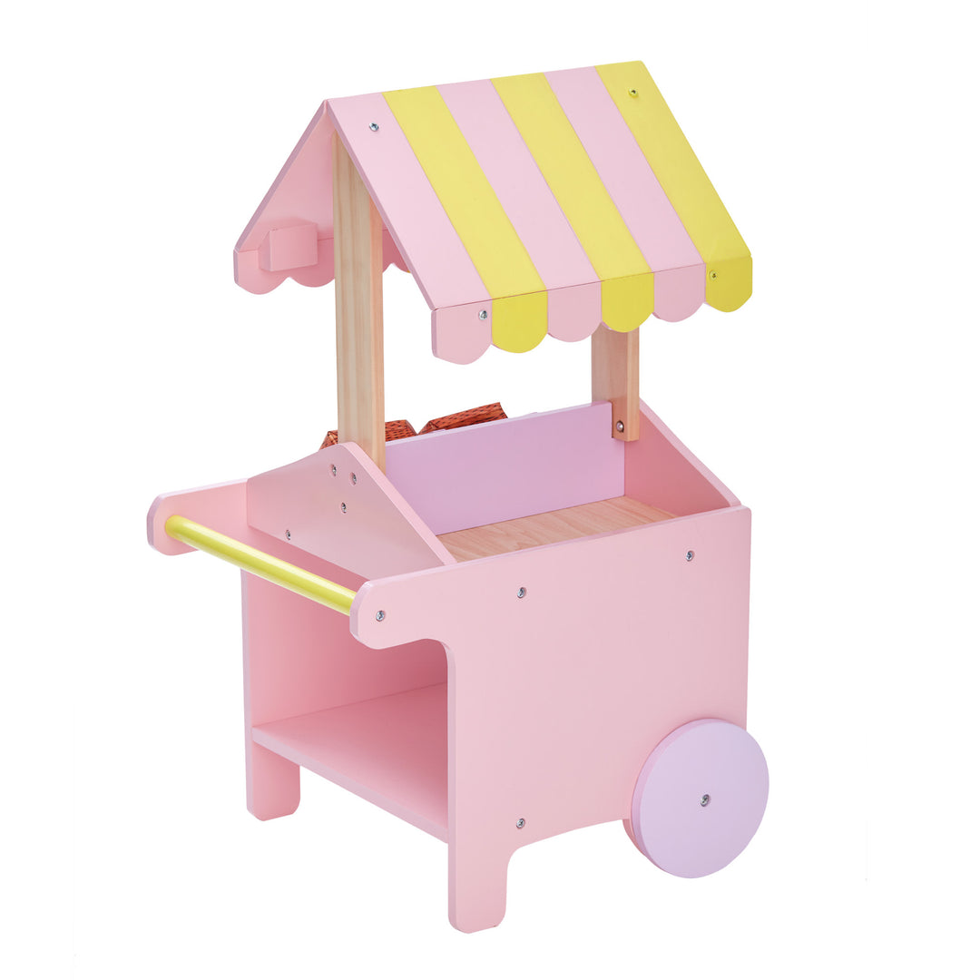A view from the side of a pink and yellow fruit stand for 18" dolls with boxes of fruit.