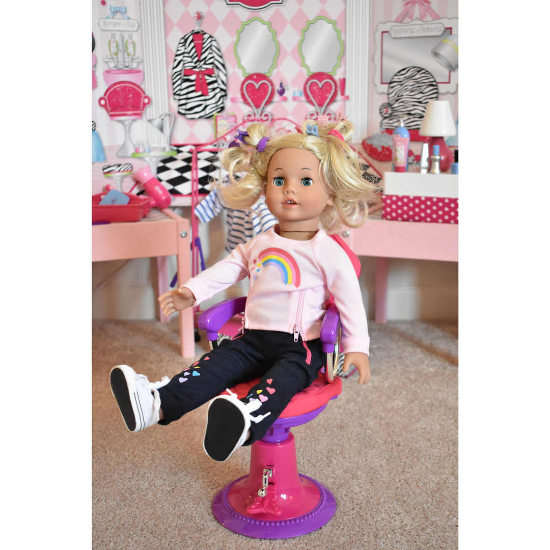 A doll sitting in a chair at Sophia's Hair Salon Complete 30 Piece Play Set for 18" Dolls.
