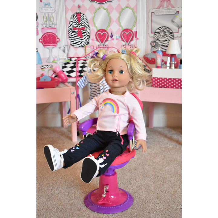 A doll sitting in a chair at Sophia's Hair Salon Complete 30 Piece Play Set for 18" Dolls.